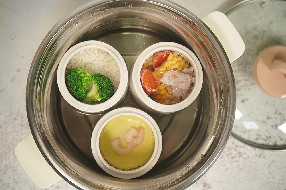 一张营养餐盘示意图,分为四个区域:左上为清蒸多宝鱼配姜丝,右上为焯水西兰花,左下为小米饭,右下为橙子切片,整体呈现科学均衡的膳食结构,背景为自然光线下的厨房环境 图片描述