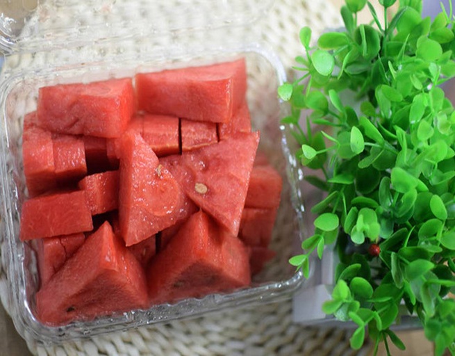 一张俯拍照片,中央是一个切开的紫薯,周围摆放西瓜片、绿豆、薄荷叶、柠檬片、黄瓜条等典型夏季解暑食材,整体呈圆形布局,背景为浅绿色餐布,传达清凉健康的主题 紫薯与其他夏季食材组合图