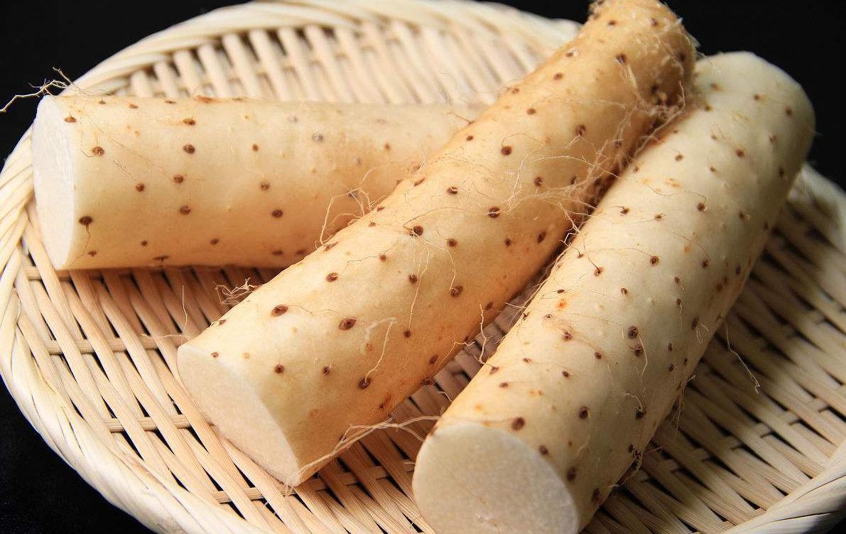 新鲜采收的山药堆放在竹筐中