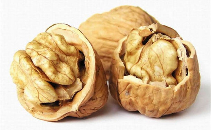双图对比摄影:左侧展示符合结石患者食用标准的原味普通核桃仁(Juglans regia),右侧展示应避免的加工核桃产品(高糖、高钠、高氧化脂肪),突出农产品本真性与加工风险差异 对比图:左侧为优质原味核桃仁(金黄饱满),右侧为加工核桃制品(琥珀核桃糖衣厚重、盐焗核桃泛油光)