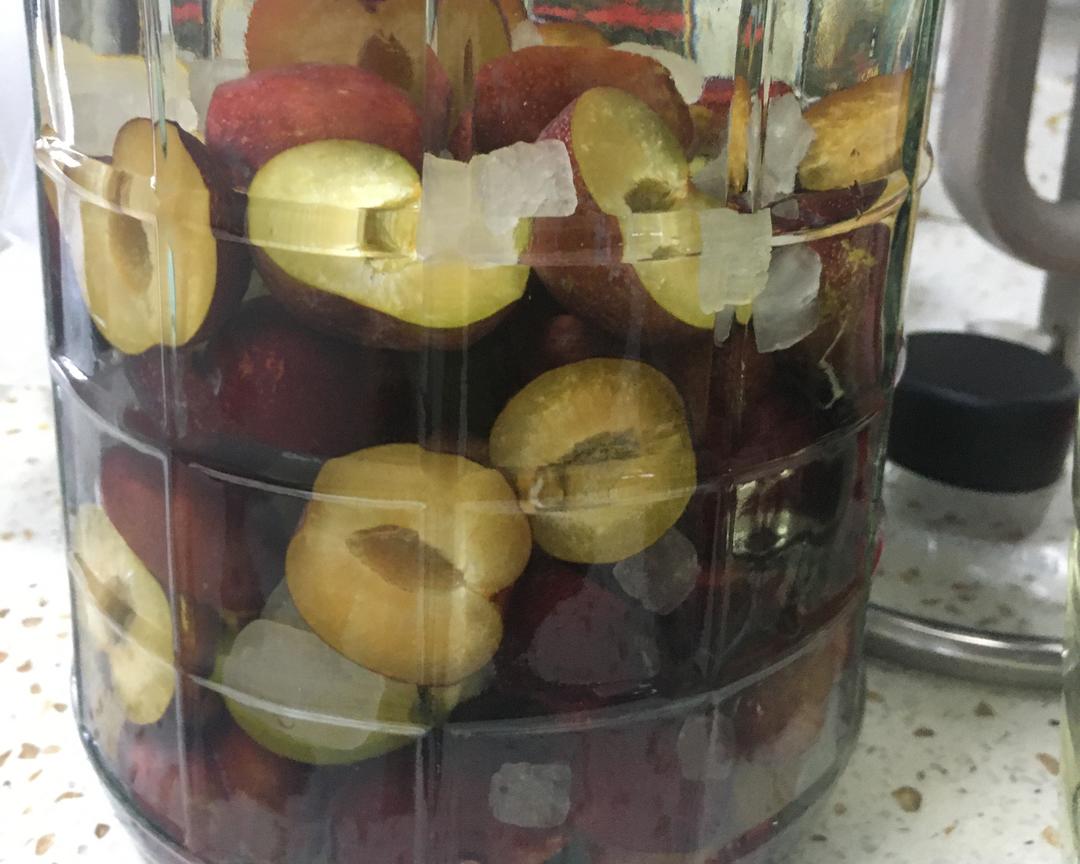 红梅果子浸泡在透明玻璃瓶中的特写