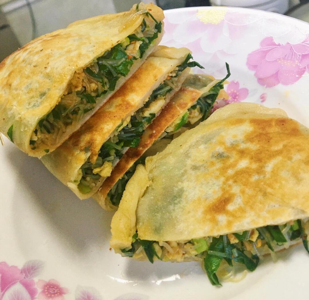 微距俯拍:刚出锅的金黄色馅饼切开横截面,外皮酥脆带芝麻粒,内馅呈现淡青绿色西葫芦碎与金黄蛋屑交织,隐约可见虾皮颗粒,饼边略带焦糖色,背景为原木色砧板 西葫芦鸡蛋素馅饼特写