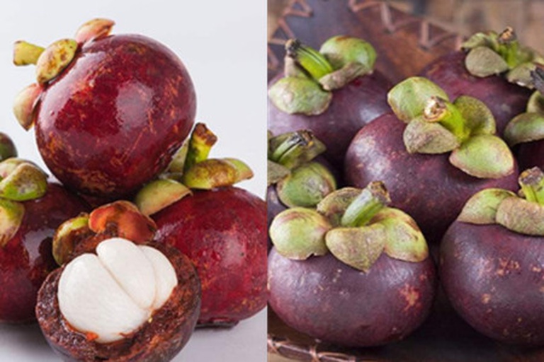 山竹果实堆放在木质桌面上，背景为自然光线，果实外壳呈深紫色，部分已剥开露出白色果肉