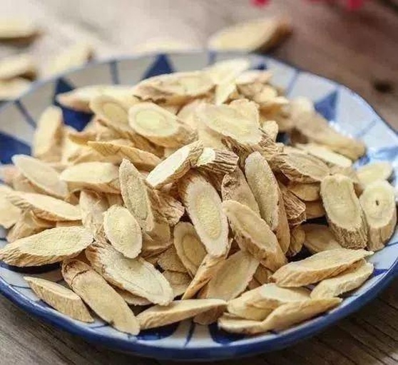 中药师正在称量黄芪片与干燥凌霄花进行配伍