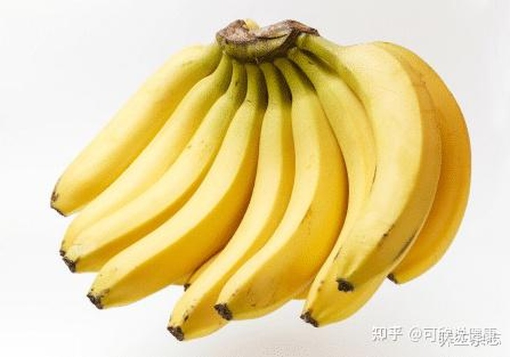 展示三组红皮香蕉:左侧为未成熟(青绿色、硬实)、中部为半成熟(浅红色、微软)、右侧为完全成熟(深紫红色、轻微微软),背景为木质桌面,光线柔和自然 红皮香蕉不同成熟阶段对比图