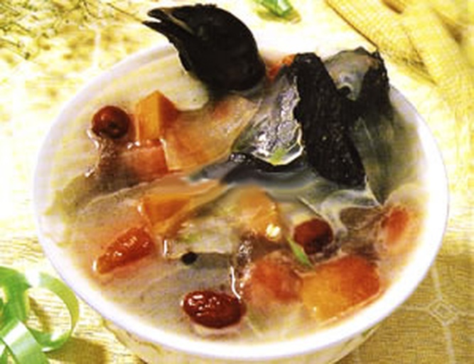 一张高清晰度的照片展示一碗刚盛出的粉葛乌鸡汤:汤色清亮呈琥珀金色,表面浮有少许油花,碗中可见完整的粉葛块、乌鸡肉块、红枣和枸杞,背景为原木餐桌与竹筷,营造温馨家常氛围 粉葛乌鸡汤成品展示