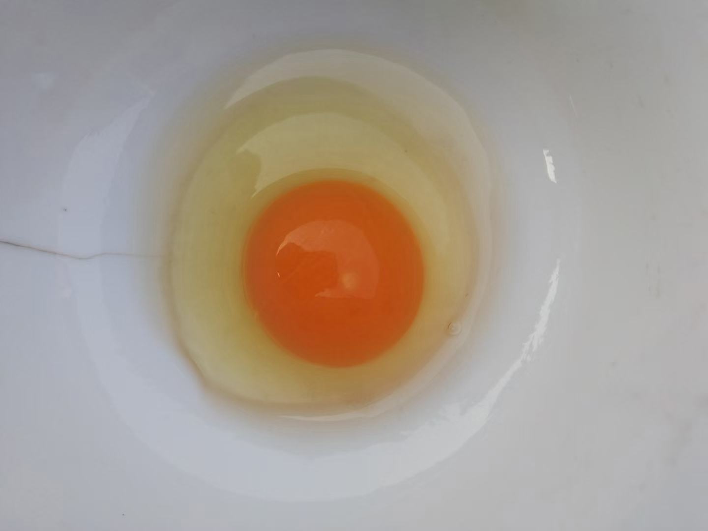 一盘刚采集的绿壳鸡蛋摆放在竹篮中，蛋壳呈淡青绿色，表面光滑洁净，旁边配有打开的鸡蛋特写，蛋清透亮、蛋黄饱满隆起