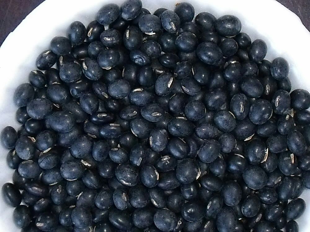 一碗热气腾腾的黑豆红枣豆浆,旁边摆放原材料黑豆与红枣 黑豆红枣豆浆成品图