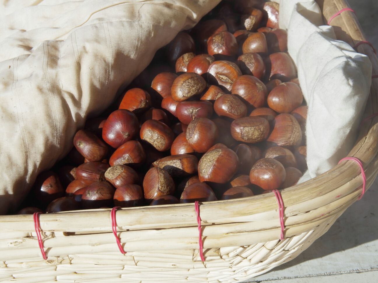 刚出锅的油炒栗子堆放在竹编小篮中,外壳油亮开裂,热气袅袅升起,旁边配有剥好的金黄栗仁特写 刚出锅的油炒栗子堆放在竹编小篮中,外壳油亮开裂,热气袅袅升起,旁边配有剥好的金黄栗仁特写