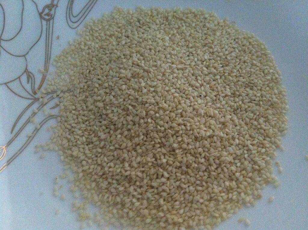 俯拍木质餐盘中分别盛放黑芝麻、白芝麻、糙米、小米、红豆等天然谷物,颜色分明,突出黑芝麻的深黑色泽及其在杂粮膳食中的搭配应用 黑芝麻与其他五谷杂粮对比图