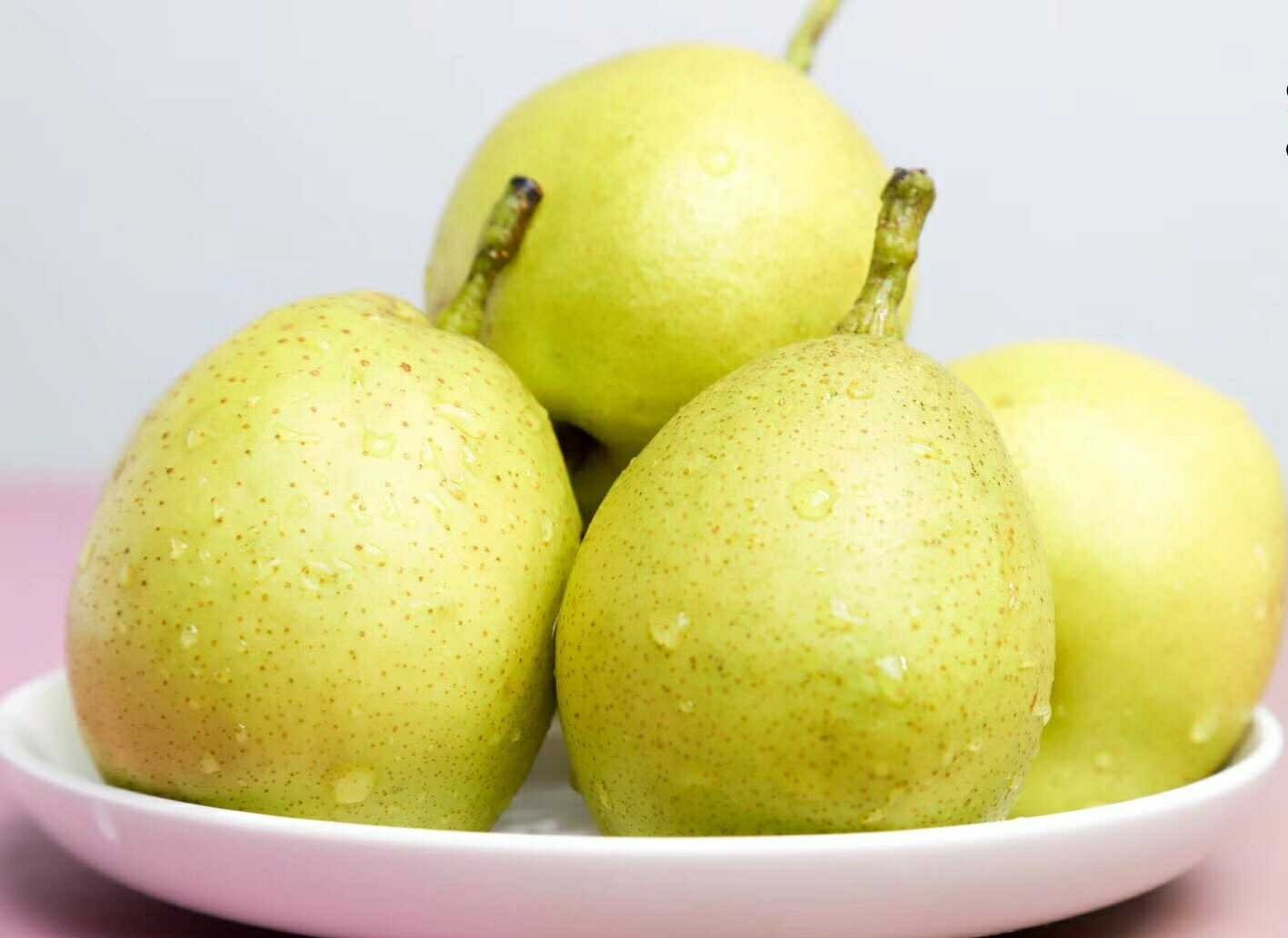 图片说明:左侧为市场摊位上整齐摆放的新鲜梨,右侧为剖开的梨切面特写,清晰展现果肉质地、汁液丰富状态及种子结构,配有‘水分足’‘纤维细’等标签注释,整体风格清新自然 新鲜梨的选购与切面展示图