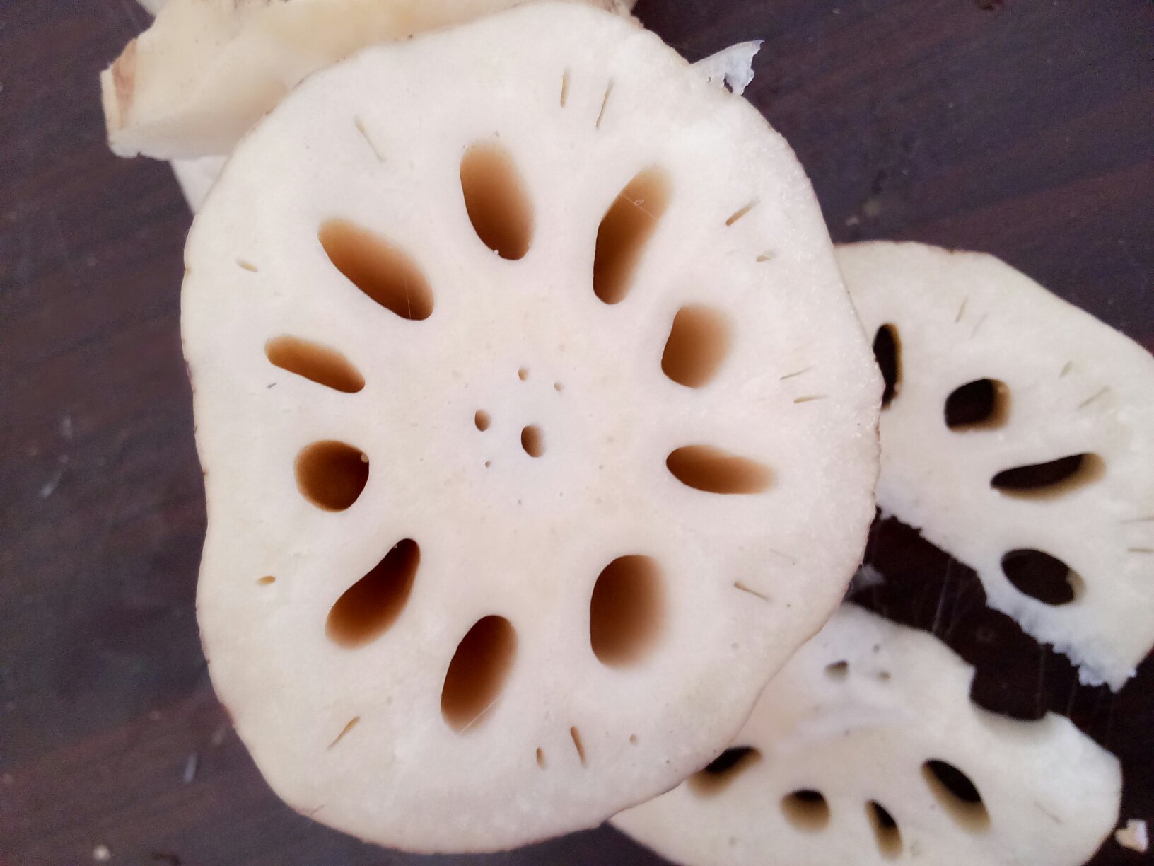 白莲藕切片后呈现清晰的孔洞结构,质地洁白细腻 白莲藕切片展示内部结构