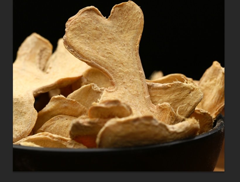 家庭厨房实操场景：厨师戴手套手持木杵在石臼中捣压子姜，背景可见砂锅中温煨的黄酒泛起细泡，台面整齐摆放冰酒水、陈皮、红枣等备料