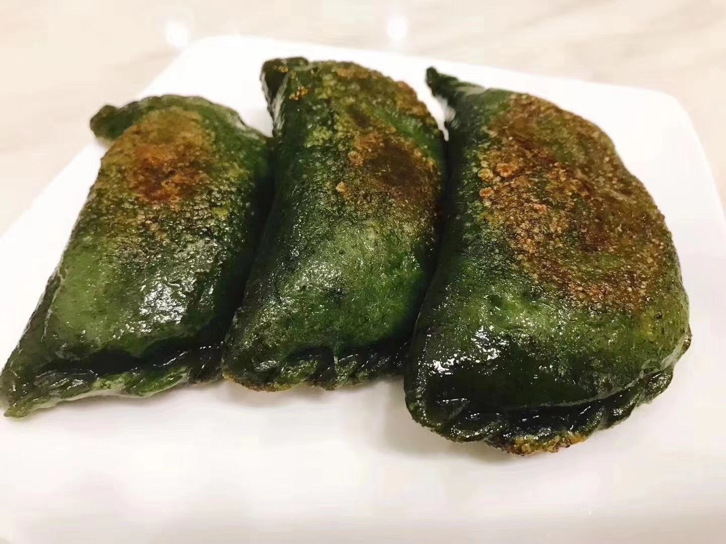 高清特写:刚出锅的油菜团子堆叠在青瓷盘中,表皮柔亮微泛油光,翠绿色泽鲜亮不暗沉,切开横截面清晰可见油菜碎、金黄蛋粒、褐色香干丁,结构紧实无空洞,热气氤氲 蒸好油菜菜团子成品特写
